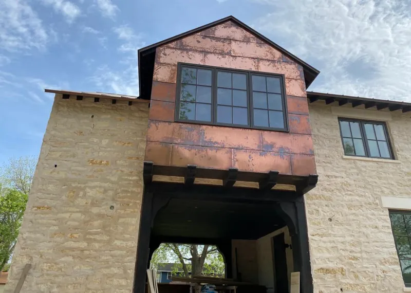 Copper metal panel facade on a stone building for Skylight Installation in Saddle Brook