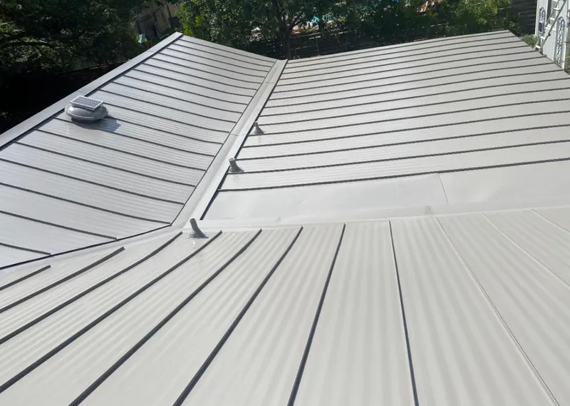 Solar attic fan installed on a metal roof for Roof Ventilation in Saddle Brook